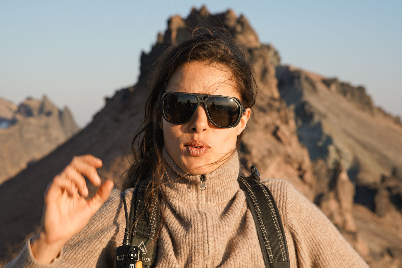 Tortoise_grey Spinning man wearing Ombraz classic tortoise grey armless sunglasses with cord