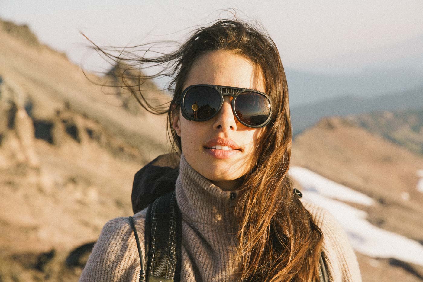 tortoise_grey Woman on her bike in the mountains wearing Ombraz classic armless string sunglasses
