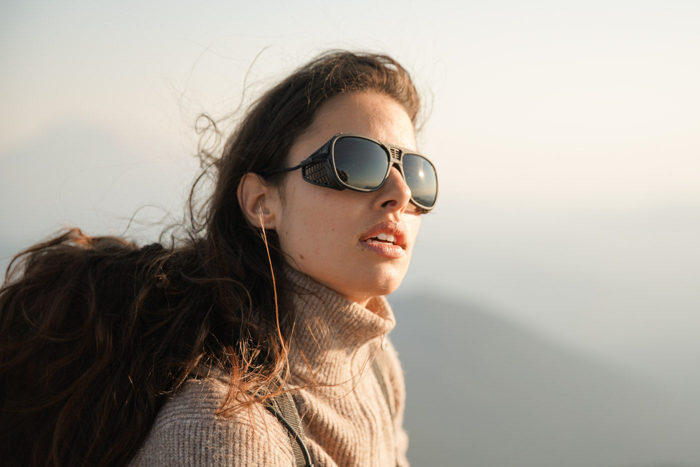 Tortoise_grey Long haired man wearing Ombraz tortoise grey classic armless sunglasses with cord