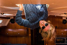 dolomite_tortoise_grey Ombraz cofounder hanging upside down from a boat wearing Ombraz dolomite armless strap sunglasses