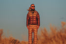 charcoal_grey Man with long hair standing in the desert wearing Ombraz classic armless string sunglasses