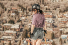 charcoal_grey Skier standing in front of a city wearing Ombraz charcoal grey classic armless sunglasses with strap