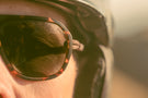 Tortoise_grey Close up of mans eye wearing Ombraz tortoise classic armless string sunglasses