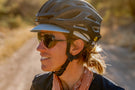 dolomite_slate_grey Smiling woman sporting Ombraz dolomite armless sunglasses over her helmet