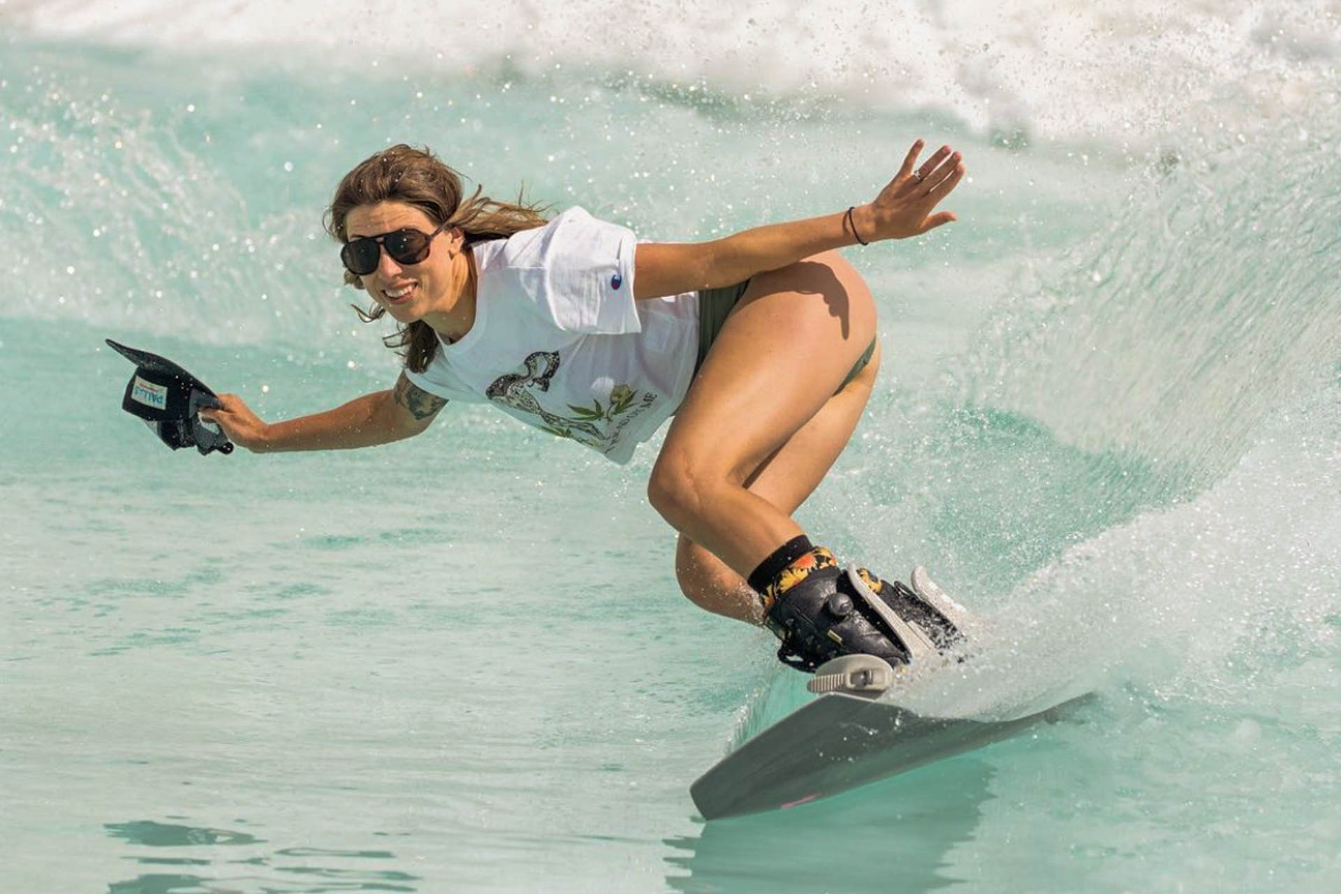 mattebrown_grey Woman surfing wearing Ombraz classic armless rope sunglasses