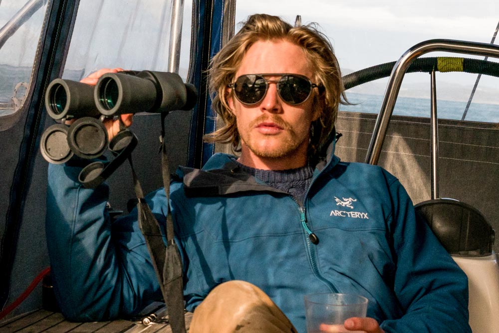 dolomite_slate_grey Man on boat with binoculars wearing Ombraz dolomite armless strap sunglasses