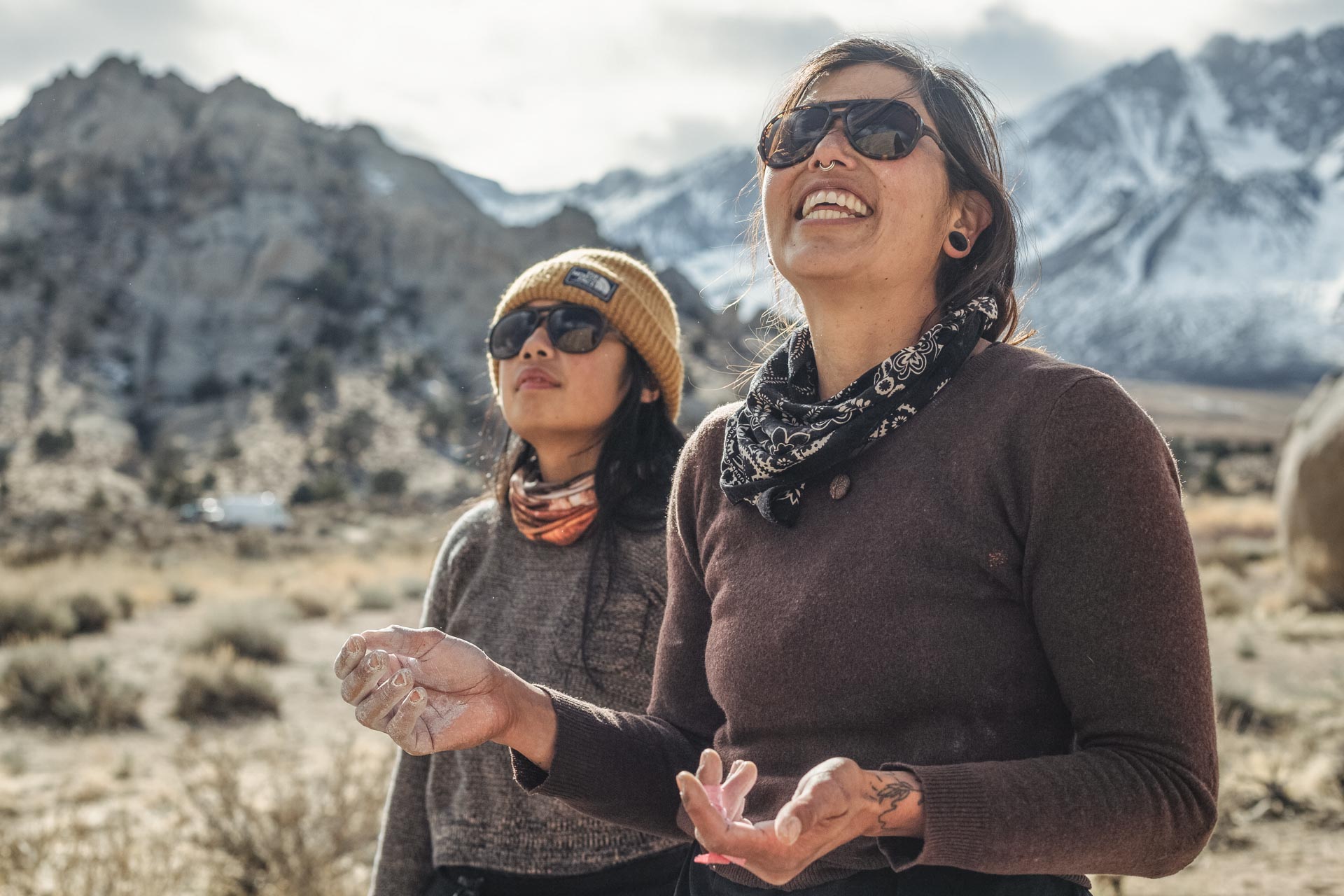 tortoise_brown Two women looking up at the mountains smiling wearing Ombraz classic armless rope sunglasses