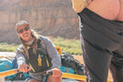 dolomite_slate_grey Man rafting and smiling wearing Ombraz dolomite armless rope sunglasses